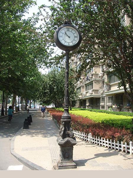 Outdoor pedestal clock with Roman Numerals
