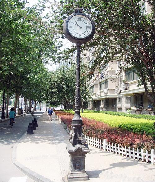 Outdoor pedestal clock with Roman Numerals